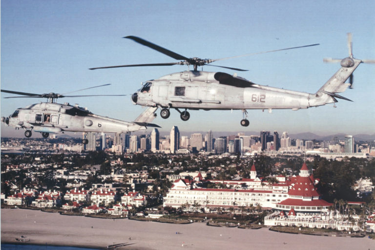 SH-60F helos with the Hotel Del Coronado in the background